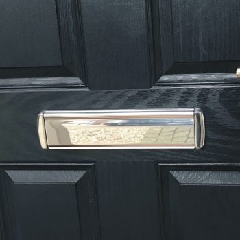 Q-Line Coastline stainless steel letterbox fitted to a black timber door