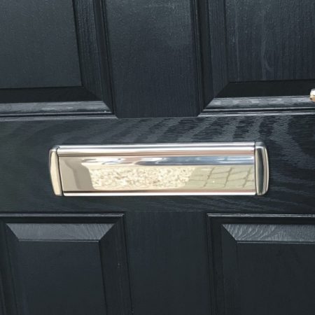 Q-Line Coastline stainless steel letterbox fitted to a black timber door