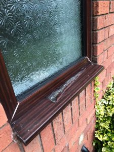 Close up image of peeling pvc foil on a window frame 