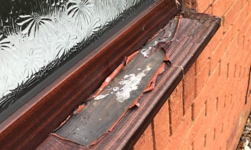 Peeling PVC foil on a window frame